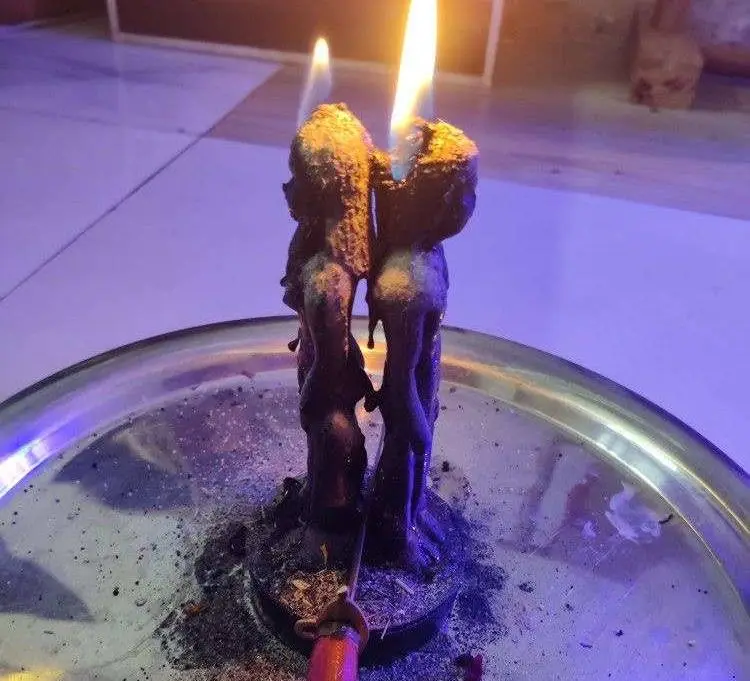 Cord Cutting Ritual in USA - Black couple candle burning down on a ritual plate