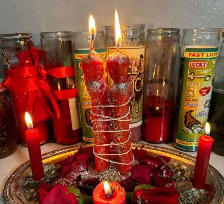 Get Back Your Lover in USA - Red couple candles bound with ribbon on a rose altar