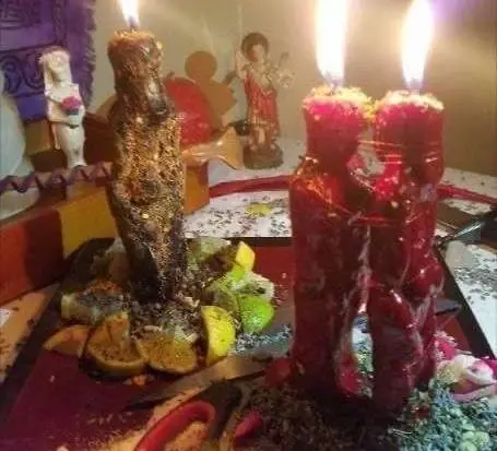 Lost Love Spell Caster in USA - Red couple candles and herbs on a candlelit altar