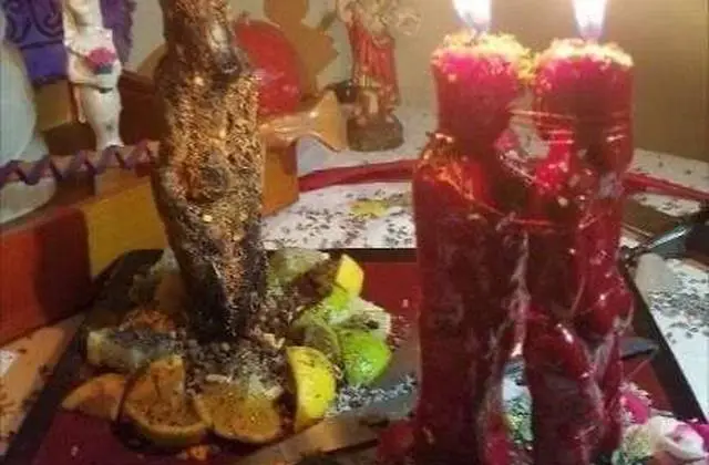 Lost Love Spell Caster in USA - Red couple candles and herbs on a candlelit altar