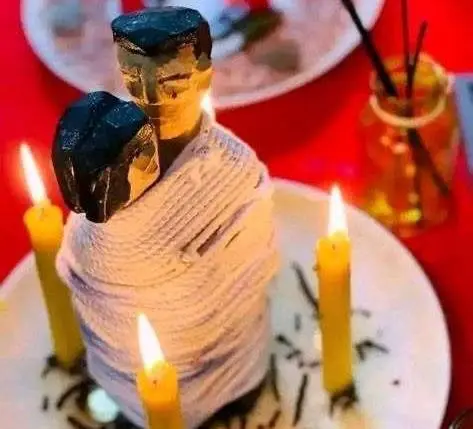 Love Binding Spell in USA - Couple figure wrapped in string between lit yellow candles