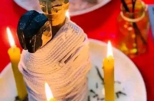 Love Binding Spell in USA - Couple figure wrapped in string between lit yellow candles