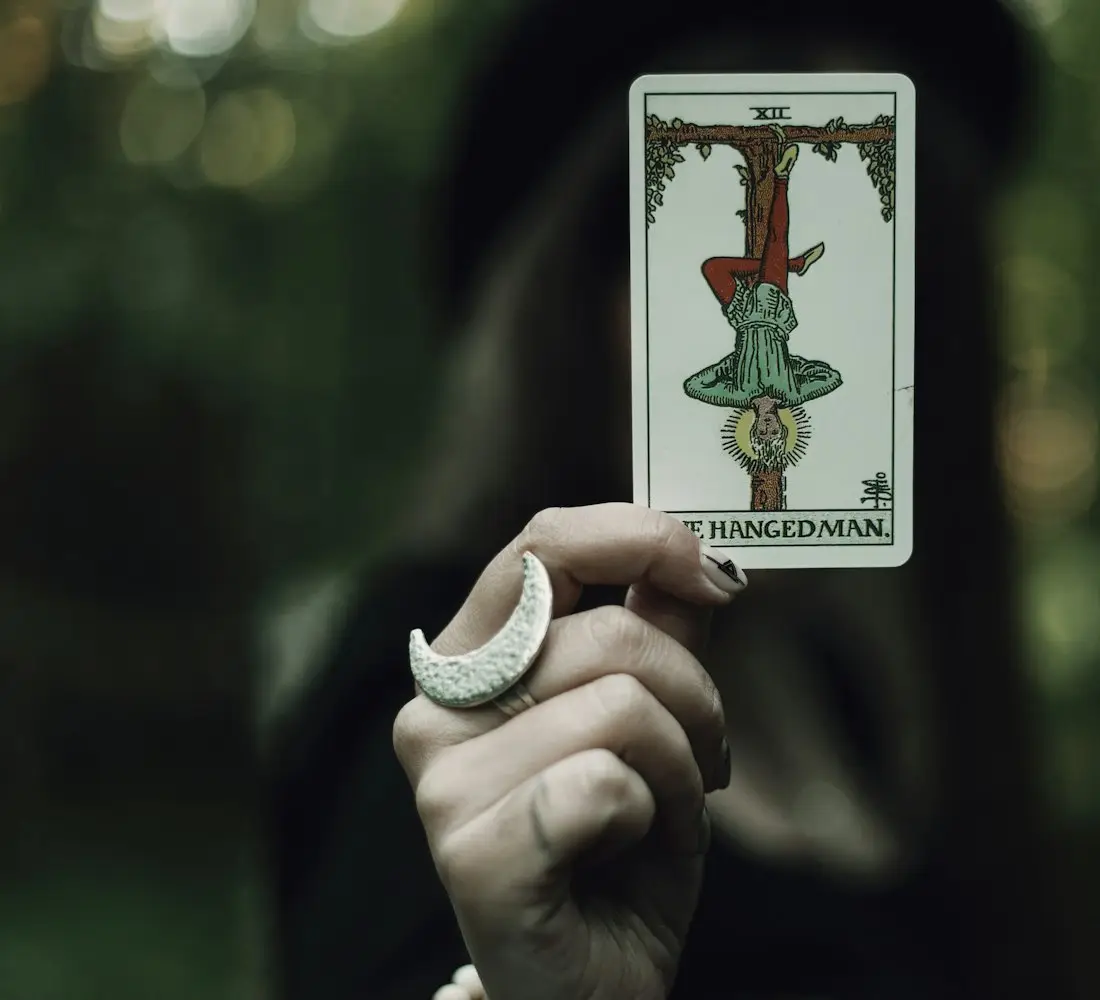 Palm Reading in USA - A hand holding a tarot card