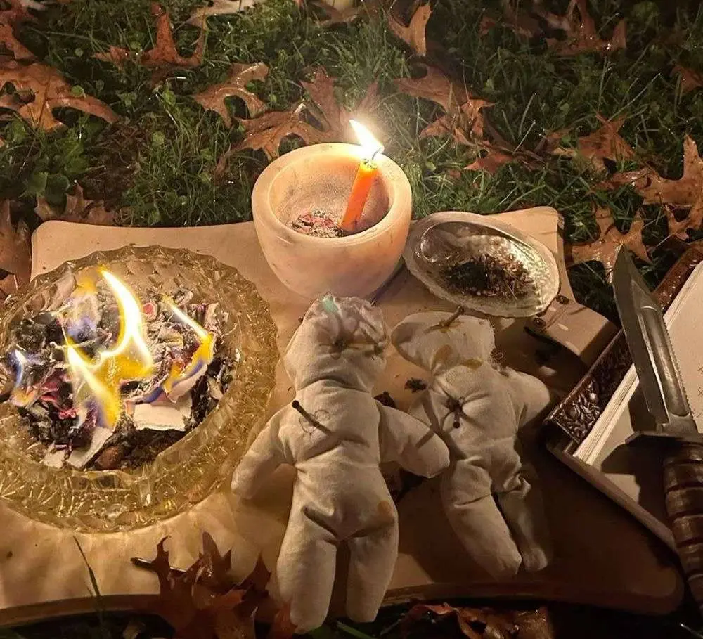 Spiritual Cleansing in USA - Burning herbs and small cloth dolls in an outdoor cleansing ritual