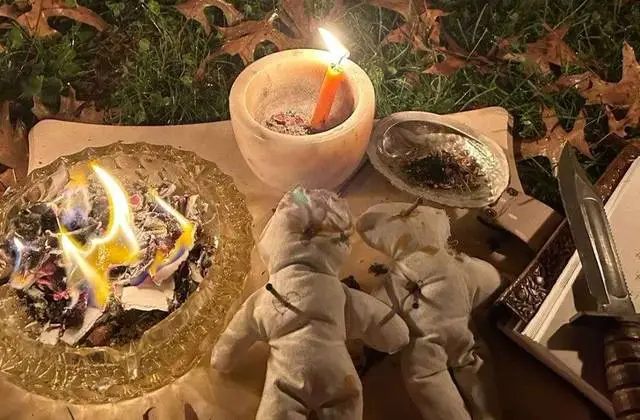 Spiritual Cleansing in USA - Burning herbs and small cloth dolls in an outdoor cleansing ritual
