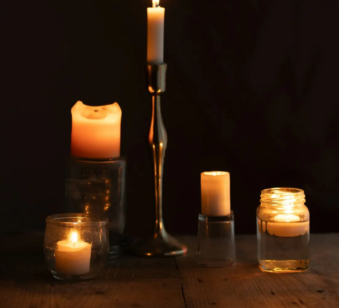 Spiritual Healing and Fertility Support in USA - Lit candles on a wooden table for prayer