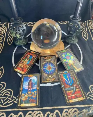 Love Spell Caster in USA - Cards symbol: crystal ball and tarot cards on a black altar cloth
